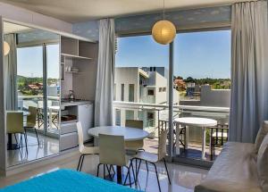 a living room with a table and a large window at Mitre Al Mar in Ostende