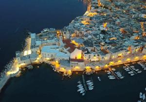 an aerial view of a harbor at night at Porto di mare luxury home in Giovinazzo