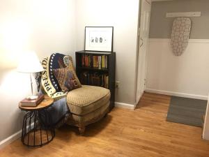 a living room with a chair and a book shelf at ~*Pet Friendly 30min to Downtown*~ THE BOSTONIAN in Boston