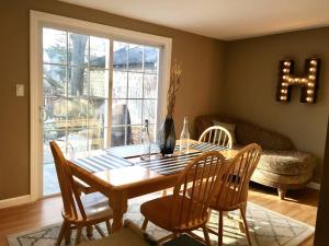 a dining room with a table and chairs and a window at ~*Pet Friendly 30min to Downtown*~ THE BOSTONIAN in Boston