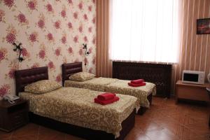 Postel nebo postele na pokoji v ubytování Voskhod Hotel