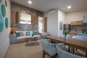 a living room with a couch and a table and chairs at Casa al Mar in La Paz