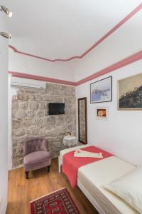 
a living room with a couch, chair and a lamp at Guesthouse Vicelic in Dubrovnik
