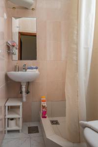 a bathroom with a sink and a shower at Guesthouse Vicelic in Dubrovnik