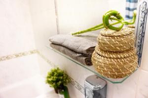 a bathroom with a rack with towels and a sink at Central Suites - Špindlerův mlýn in Špindlerův Mlýn