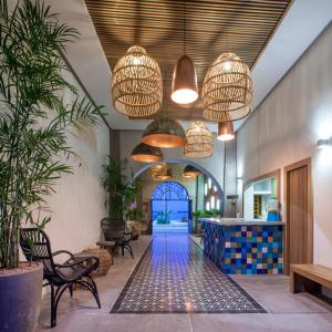 a lobby with potted plants and pendant lights at Casa al Mar in La Paz