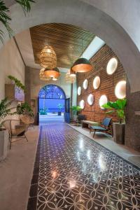 a lobby with a tile floor and chandeliers at Casa al Mar in La Paz