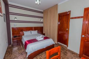 Postelja oz. postelje v sobi nastanitve Hotel Suite Naylamp Zyon