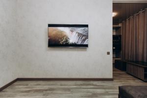 a television hanging on a wall in a room at Greatest Luxury Apartment in Sumy