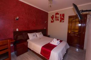 Postelja oz. postelje v sobi nastanitve Hotel Suite Naylamp Zyon