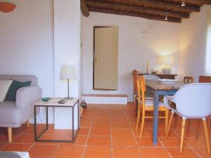 a living room with a table and a dining room at Monte do Alentejo | Cozy Cottage in Redondo +35 photos