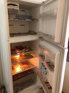 a refrigerator with its door open and its doorsktopktopktopktopktopktopktop at Cozy new 2 BD Amazing beach view Next to Hilton hotel Family only !العائلات فقط in Alexandria