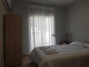 a bedroom with a large bed and a large window at Apartamento Centro de Granada in Granada