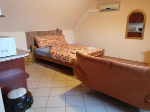 a bed room with a couch and a table at Apartman116 Airport in Vecsés