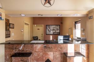 a lobby with a reception desk and a phone at Super 8 Dallas-Mesquite in Dallas
