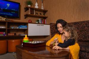 a woman and a little girl sitting at a table at Coconut Waikiki Hotel in Honolulu