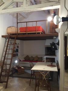 a bunk bed in a room with a table and a desk at Old castle S. Croce in Cagliari