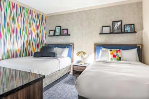 a bedroom with two beds and a colorful wall at Signature San Francisco in San Francisco