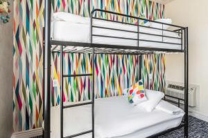 a bedroom with two bunk beds with a colorful wallpaper at Signature San Francisco in San Francisco