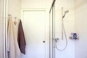 a shower with a glass door in a bathroom at Studio 25 Davos Platz in Davos +5 photos