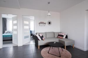 a living room with a couch and a table at Legnica Apartament 52m2 Delux 1 in Legnica