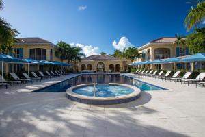 a swimming pool with chairs and a resort at Villa Renaissance in The Bight Settlements