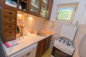 a small kitchen with a sink and a stove at Apartments Ziva in Primošten
