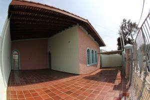 a brick building with a brick walkway next to a fence at Pousada Santa Genebra in Campinas