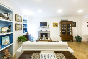 a living room with a white couch and a fireplace at Residenza San Luca Praiano in Praiano