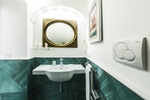 a bathroom with a sink and a mirror at Residenza San Luca Praiano in Praiano +18 photos