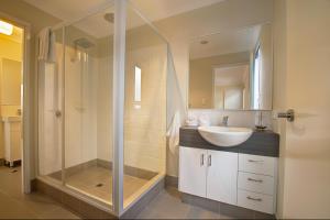 a bathroom with a glass shower and a sink at A Little Luxury in Town in Dunsborough