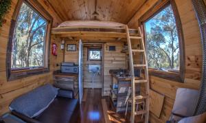 a tiny house with a bunk bed and a desk at Hilltop Tiny House in Tallarook