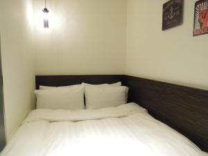 Postel nebo postele na pokoji v ubytování Re-Change Hotel Taipei