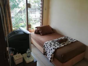 Postel nebo postele na pokoji v ubytování GIO Guesthouse Bogor