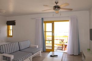a living room with a couch and a ceiling fan at Kaliva 595 in Langebaan