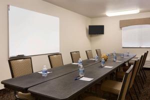 a conference room with a long table with bottles of water at Travelodge by Wyndham Santa Teresa in Santa Teresa
