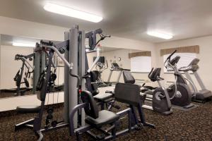 a gym with treadmills and elliptical machines at Baymont by Wyndham Glendive in Glendive