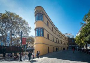 a building with people standing outside of it at Moon and Chalice Boutique Hotel in Kunming