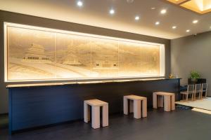 a large painting on the wall of a restaurant with stools at GRANDVRIO HOTEL NARA -WAKURA- -ROUTE INN HOTELS- in Tenri
