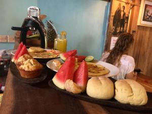 a table topped with plates of bread and fruit at Villa Monyet Java in Batukaras
