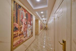 a hallway with a large painting on the wall at Реверанс отель in Saint Petersburg