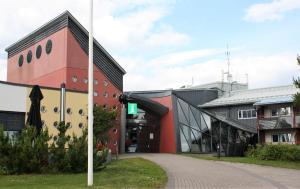 a large building with a sign on the side of it at Hotelli Kivitippu in Lappajärvi