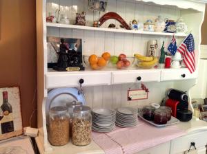 a cupboard filled with plates and bowls of food at Annandale House in Dublin