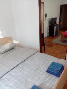 a bedroom with a bed with blue towels on it at city center apartment 1 in Niš