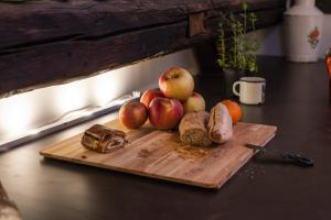 a wooden cutting board topped with a cut up apple at Das Nest Budapest in Budapest