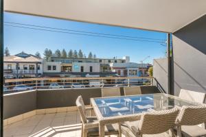 a balcony with a table and chairs on a balcony at Byron Bay Accom Unit 2 8 Lawson Street, Byron Bay - Absolute Solace in Byron Bay