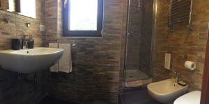 a bathroom with a sink and a shower and a toilet at Villa dei Pini in Pescasseroli +48 photos