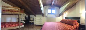 a bedroom with two bunk beds and a window at Villa dei Pini in Pescasseroli