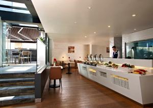 a kitchen with a counter with food on it at Aqueen Hotel Kitchener in Singapore