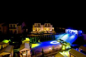 an image of a house with a swimming pool at night at Elegant Hotel & Resort in Tsaghkadzor